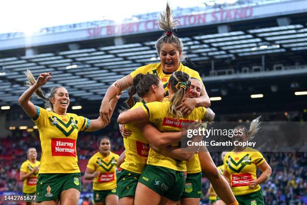 Julia Robinson of Australia celebrates their sides third try with teammates during the Women's Rugby League World Cup Final match between Australia...