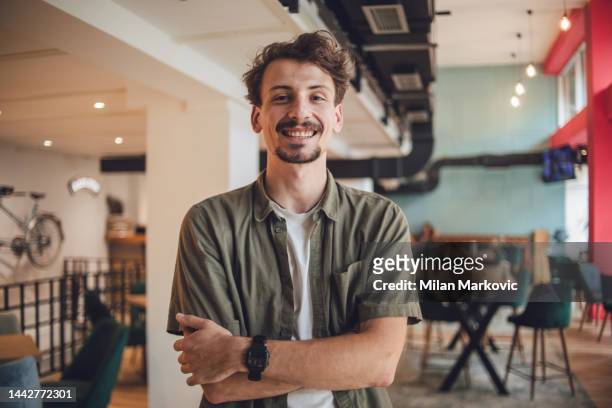 front view portrait of a modern man standing with arms crossed, looking at the camera - mustache stock pictures, royalty-free photos & images
