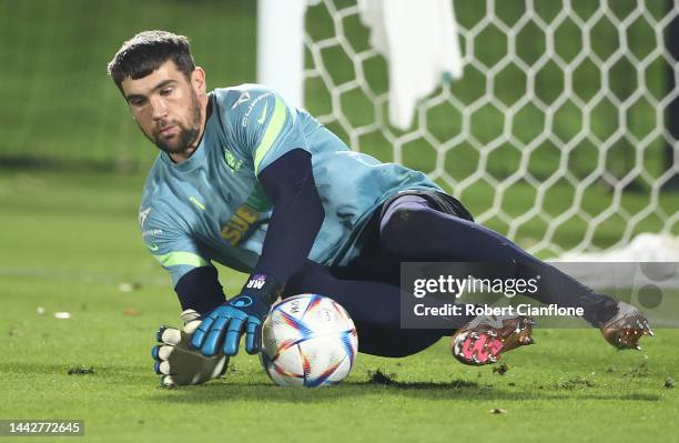 Australian goalkeeper Mathew Ryan dives for the ball during the Australia training session at Apsire Training Ground on November 19, 2022 in Doha,...