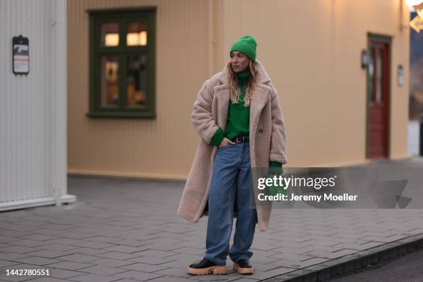 Sonia Lyson is seen wearing a beige Ducie London teddy coat, Bottega Veneta mini green Jodie bag, Copenhagen Studios CPH 246 pale beige boots, blue...