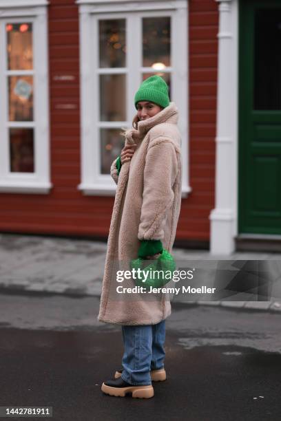 Sonia Lyson is seen wearing a beige Ducie London teddy coat, Bottega Veneta mini green Jodie bag, Copenhagen Studios CPH 246 pale beige boots, blue...