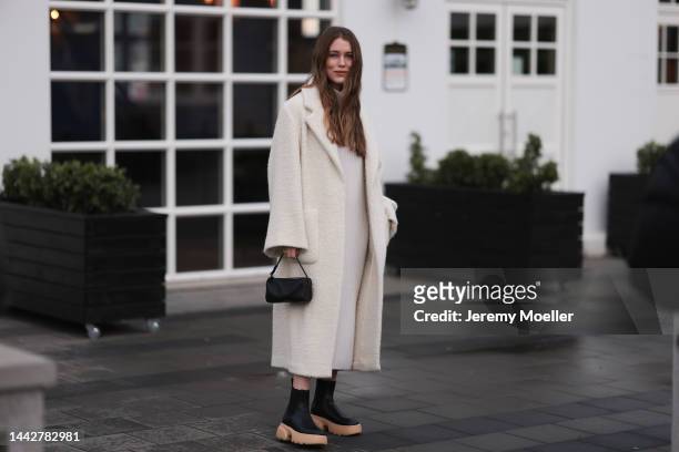 Annabel Rosendahl is seen wearing Copenhagen Studios CPH 276 Vitello black/ pale beige boots, Dorothee Schumacher creme white wool coat, The Row...