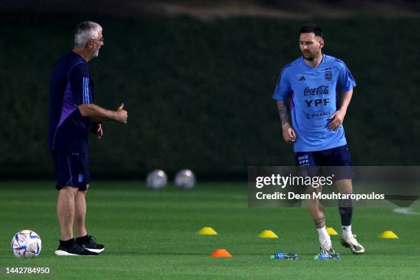 Lionel Messi of Argentina trains away from the main squad with the medical adviser during the training session for Team Argentina at Qatar University...