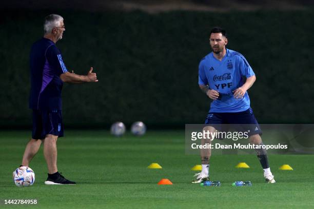 Lionel Messi of Argentina trains away from the main squad with the medical adviser during the training session for Team Argentina at Qatar University...
