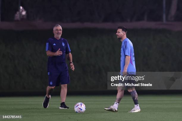 Lionel Messi of Argentina trains alone from the main squad alongside Javier Hernandez the medical officer during the Argentina training session at...