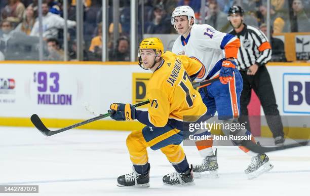 Mark Jankowski of the Nashville Predators skates against Mathew Barzal of the New York Islanders during an NHL game at Bridgestone Arena on November...