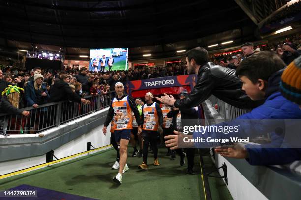 Kevin Sinfield, former Rugby League player, walks out onto the field at half time after completing their Ultra 7 in 7 Challenge during the Rugby...