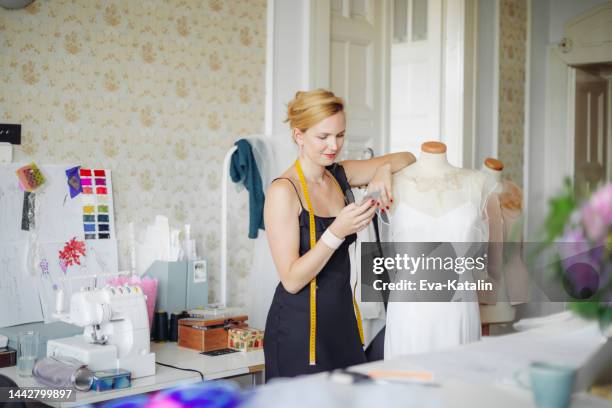 fashion designer at her showroom - bridal shop stock pictures, royalty-free photos & images