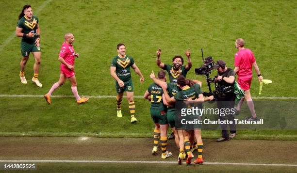 James Tedesco of Australia celebrates with teammates after scoring their team's fifth try during the Rugby League World Cup Final match between...