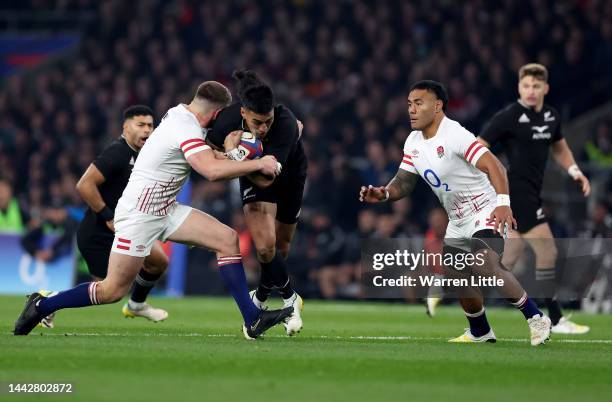 Rieko Loane of New Zealand is tackled by Owen Farrell of England during the Autumn International match between England and New Zealand at Twickenham...