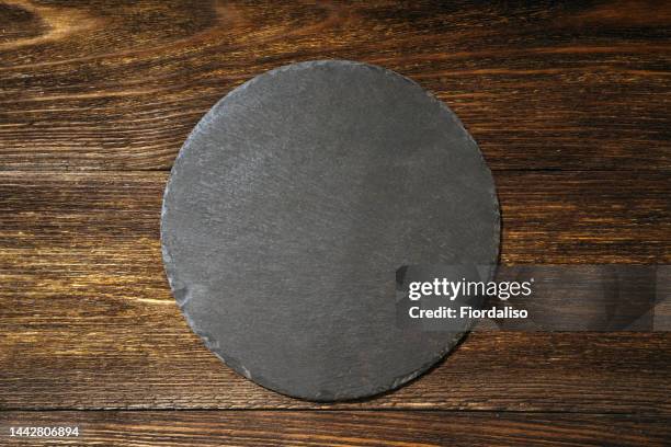 dark wooden background - round wooden chopping board stock pictures, royalty-free photos & images