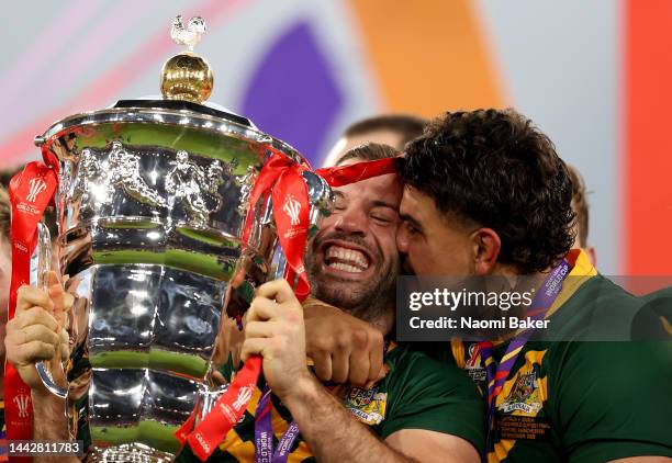 James Tedesco of Australia lifts the Rugby League World Cup trophy with teammates following victory in the Rugby League World Cup Final match between...