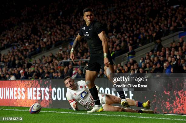 Rieko Ioane of New Zealand celebrates after scoring their team's third try as Jonny May of England reacts during the Autumn International match...