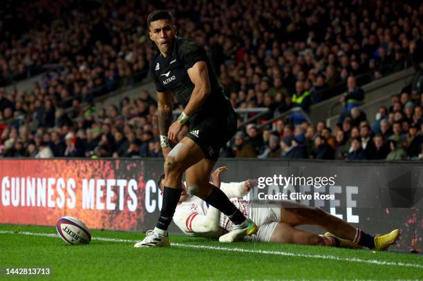 Rieko Ioane of New Zealand celebrates after scoring their team's third try as Jonny May of England reacts during the Autumn International match...