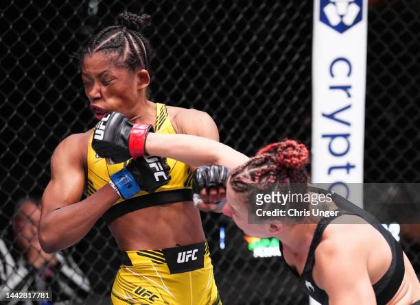 Vanessa Demopoulos punches Maria Oliveira of Brazil in a strawweight fight during the UFC Fight Night event at UFC APEX on November 19, 2022 in Las...