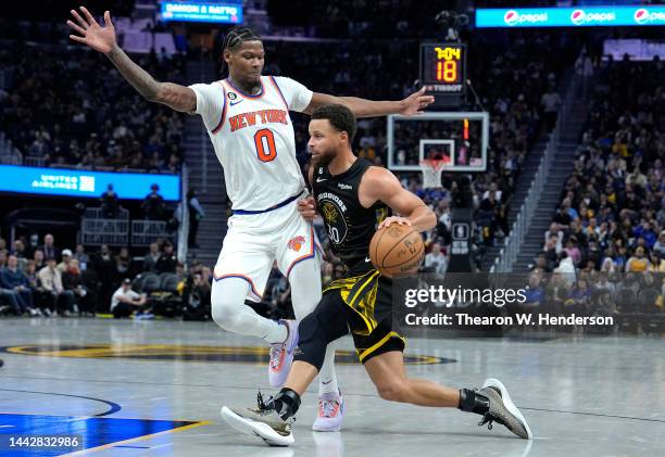 Stephen Curry of the Golden State Warriors drives on Cam Reddish of the New York Knicks during the third quarter of an NBA basketball game at Chase...