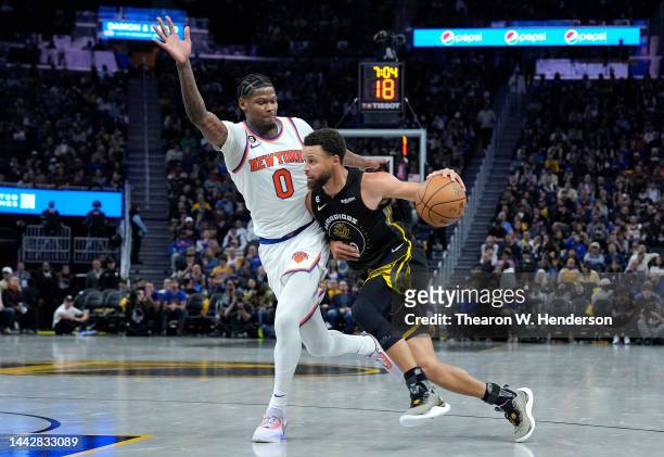 Stephen Curry of the Golden State Warriors drives on Cam Reddish of the New York Knicks during the third quarter of an NBA basketball game at Chase...