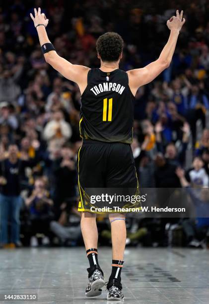 Klay Thompson of the Golden State Warriors celebrates after he made a three-point shot against the New York Knicks during the fourth quarter of an...