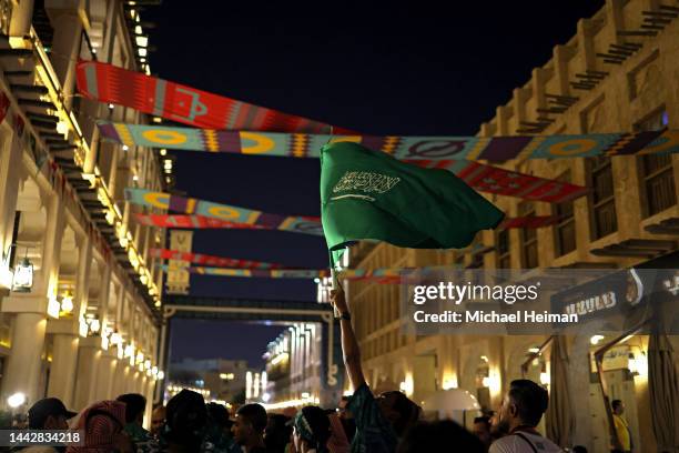 Fan waves a Saudi Arabian Flag while walking through the Souq Waqif ahead of the FIFA World Cup Qatar 2022 at on November 19, 2022 in Doha, Qatar.