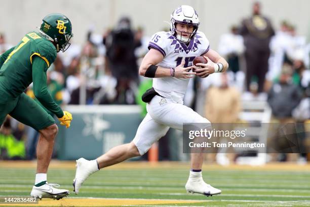 Quarterback Max Duggan of the TCU Horned Frogs scrambles with the ball against linebacker Bryson Jackson of the Baylor Bears in the fourth quarter at...