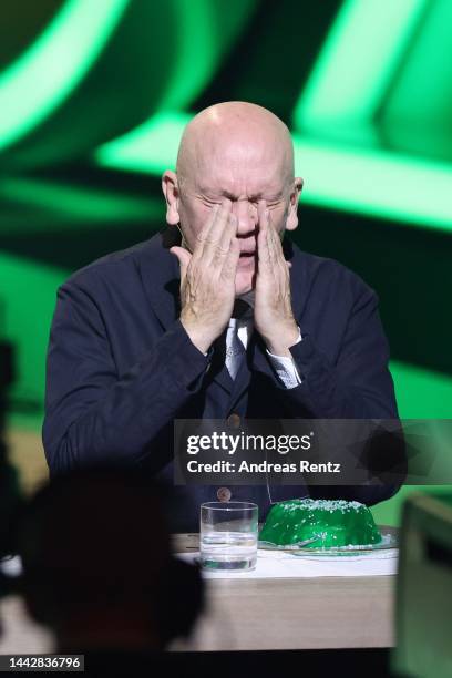 John Malkovich reacts after eating green jelly on stage during the "Wetten, dass...?" Live Show on November 19, 2022 in Friedrichshafen, Germany.