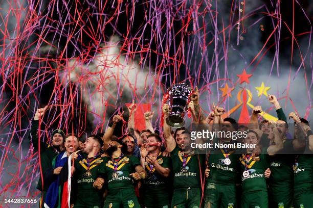 James Tedesco of Australia lifts the Rugby League World Cup trophy with teammates following victor during the Rugby League World Cup Final match...