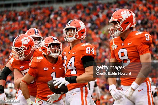 Davis Allen of the Clemson Tigers celebrates with his teammates after his first quarter touchdown against the Miami Hurricanes at Memorial Stadium on...