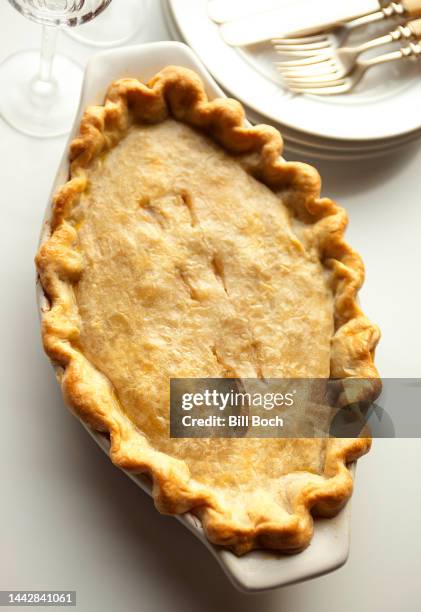 whole chicken pot pie in a baking dish - meat pie stock pictures, royalty-free photos & images