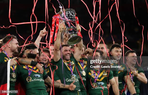 James Tedesco of Australia lifts the Rugby League World Cup trophy with teammates following victory in the Rugby League World Cup Final match between...