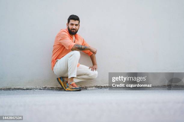fashionable young man posing on the street - mens street style stock pictures, royalty-free photos & images