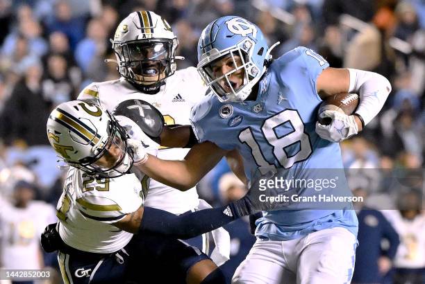 Bryson Nesbit of the North Carolina Tar Heels stiff-arms Clayton Powell-Lee of the Georgia Tech Yellow Jackets during the first half of their game at...