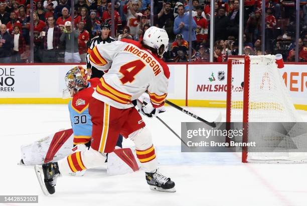 Rasmus Andersson of the Calgary Flames scores the shootout winning goal against Spencer Knight of the Florida Panthers at FLA Live Arena on November...