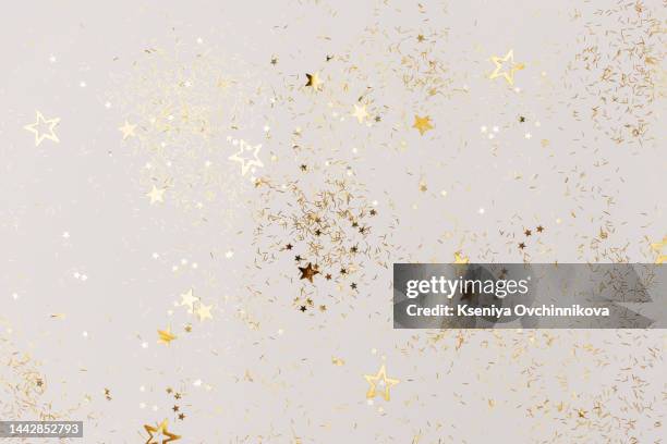 bunch of gold stars on white background. festive concept. - lametta stock-fotos und bilder