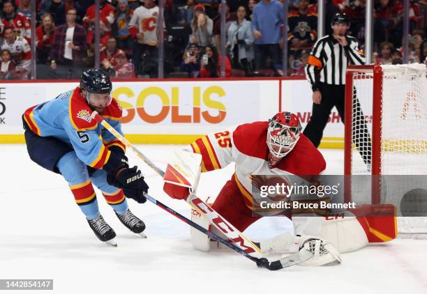 Jacob Markstrom of the Calgary Flames makes the overtime save on Aaron Ekblad of the Florida Panthers at FLA Live Arena on November 19, 2022 in...