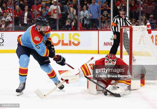 Jacob Markstrom of the Calgary Flames makes the overtime save on Aaron Ekblad of the Florida Panthers at FLA Live Arena on November 19, 2022 in...