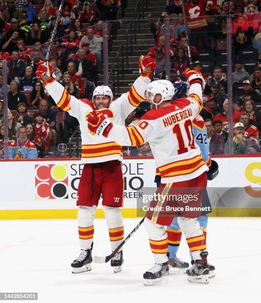 Blake Coleman of the Calgary Flames celebrates his third period goal against the Florida Panthers and is joined by Jonathan Huberdeau at FLA Live...