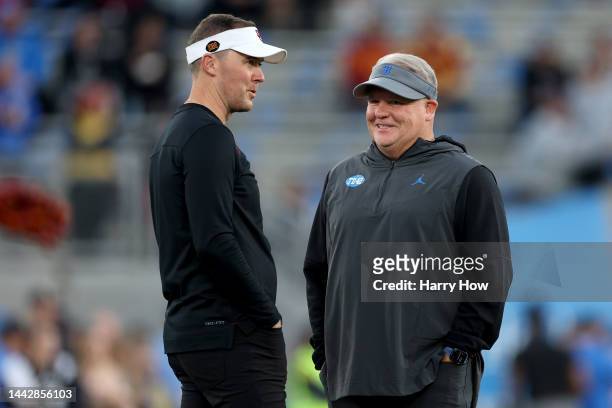 Head coach Lincoln Riley of the USC Trojans and head coach Chip Kelly of the UCLA Bruins talk prior to the game at Rose Bowl on November 19, 2022 in...