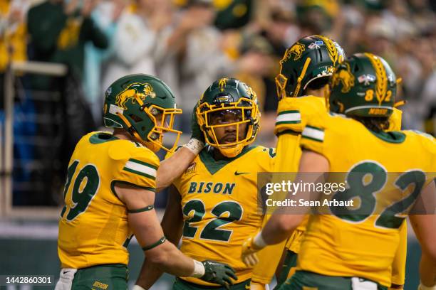 TaMerik Williams of the North Dakota State Bison celebrates with teammates after scoring a touchdown in the first half against the North Dakota...
