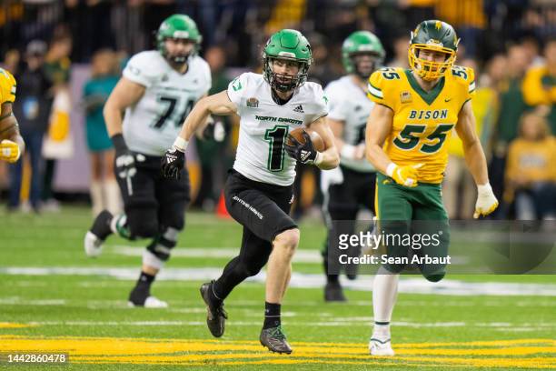 Bo Belquist of the North Dakota Fighting Hawks runs down the field after catching a pass in the first half against the North Dakota State Bison at...