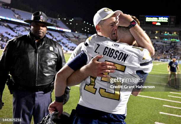 Zach Gibson hugs head coach Brent Key of the Georgia Tech Yellow Jackets after their win against the North Carolina Tar Heels at Kenan Memorial...