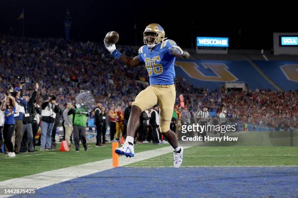 Michael Ezeike of the UCLA Bruins celebrates after scoring a touchdown against the USC Trojans during the first quarter in the game at Rose Bowl on...