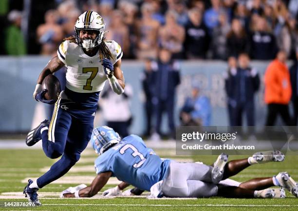 Malachi Carter of the Georgia Tech Yellow Jackets breaks away from Storm Duck of the North Carolina Tar Heels during the second half of their game at...