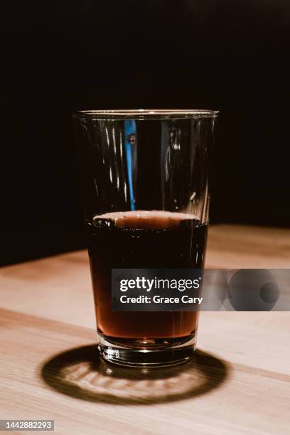 half full glass of soda on restaurant table - half photos et images de collection