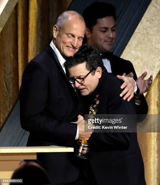 Woody Harrelson congratulates Michael J. Fox, winner of the Jean Hersholt Humanitarian Award, onstage during the Academy of Motion Picture Arts and...