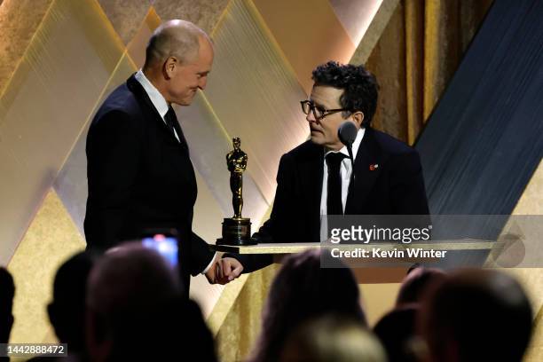 Woody Harrelson and Michael J. Fox, winner of the Jean Hersholt Humanitarian Award, speak onstage during the Academy of Motion Picture Arts and...
