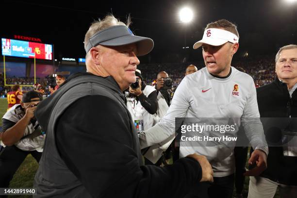 Head coach Chip Kelly of the UCLA Bruins shakes hands with head coach Lincoln Riley of the USC Trojans after the game at Rose Bowl on November 19,...