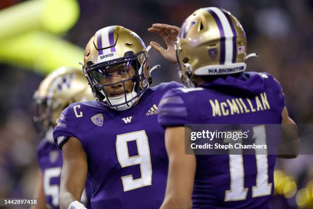 Michael Penix Jr. #9 and Jalen McMillan of the Washington Huskies celebrate a touchdown against the Colorado Buffaloes during the second quarter at...