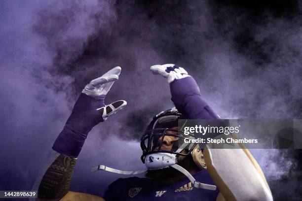 Troy Fautanu of the Washington Huskies enters the field through purple smoke before the game against the Colorado Buffaloes at Husky Stadium on...