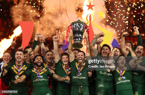 James Tedesco of Australia lifts the Rugby League World Cup trophy with teammates following victory during the Rugby League World Cup Final match...