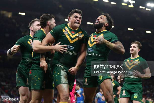 Latrell Mitchell of Australia celebrates with teammates Nathan Cleary and Josh Addo-Carr after scoring their team's sixth try during the Rugby League...